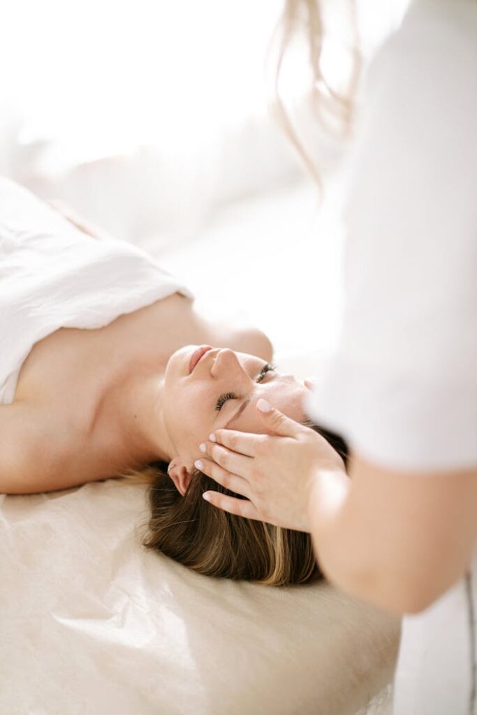 Offerings Woman enjoying a calming head massage at a spa, promoting relaxation.